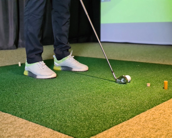 close up man playing golf simulator